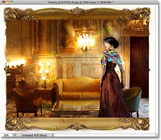 The photo appears in front of the frame in the document. Image © 2011 Photoshop Essentials.com