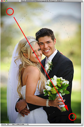 Dragging out an oval selection with the Elliptical Marquee Tool in Photoshop. Image © 2009 Photoshop Essentials.com