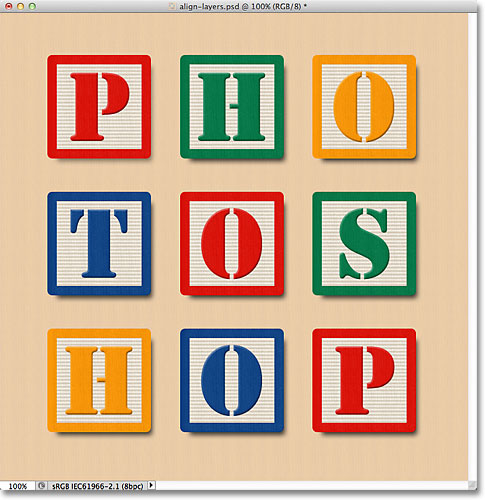 The blocks are now aligned horizontally with the Background layer and centered in the document. Image © 2011 Photoshop Essentials.com