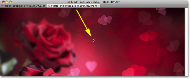 Dragging the photo into the other document. Image © 2011 Photoshop Essentials.com