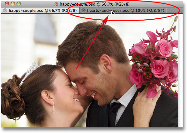 Dragging the first photo onto the name tab of the second photo. Image © 2011 Photoshop Essentials.com
