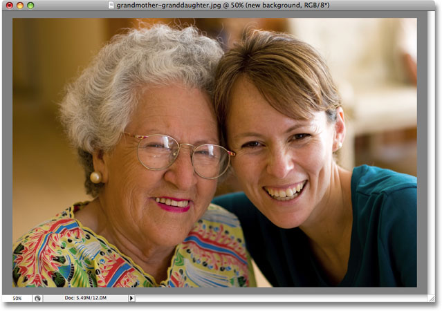 The image on the 'photo corners' layer is now visible in front of the gray background. Image copyright © 2008 Photoshop Essentials.com