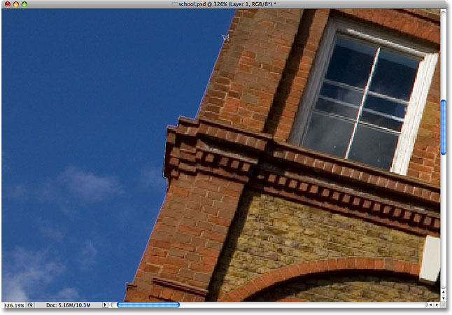 Drawing a selection around the edge of the building with the Polygonal Lasso Tool. Image © 2009 Photoshop Essentials.com