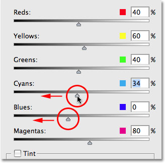 Dragging the Blue and Cyan slider towards the left to darken the sky. Image © 2009 Photoshop Essentials.com.