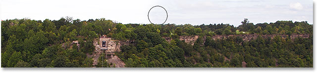 Painting with black on the layer mask to reveal the original sky. Image © 2013 Steve Patterson, Photoshop Essentials.com.