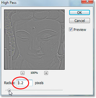 Dragging the slider bar to adjust the amount of sharpening in the image.