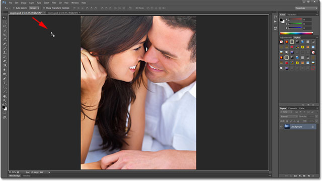 Dragging the second image down into the first image's document. Image © 2013 Photoshop Essentials.com