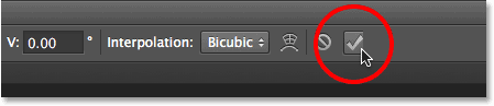 Clicking the checkmark in the Options Bar. Image © 2013 Photoshop Essentials.com