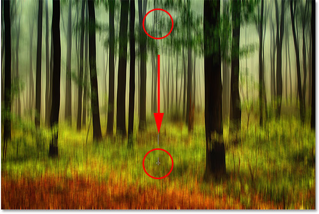 Dragging out a black to white gradient on the Smart Filter layer mask. Image © 2013 Photoshop Essentials.com
