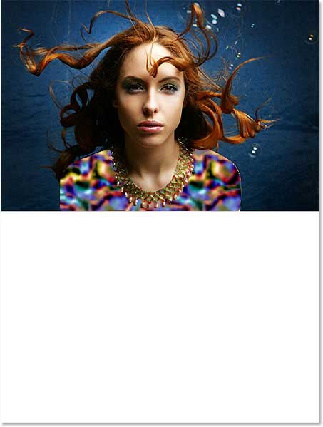 The added canvas space appears below the image. Image © 2013 Photoshop Essentials.com
