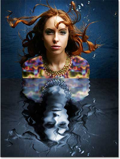 The water reflection area is now colorized with blue. Image © 2013 Photoshop Essentials.com