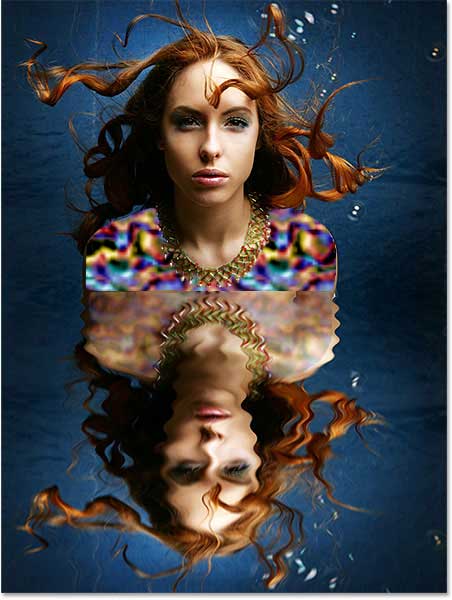 The image after adding the layer mask to the top layer. Image © 2013 Photoshop Essentials.com